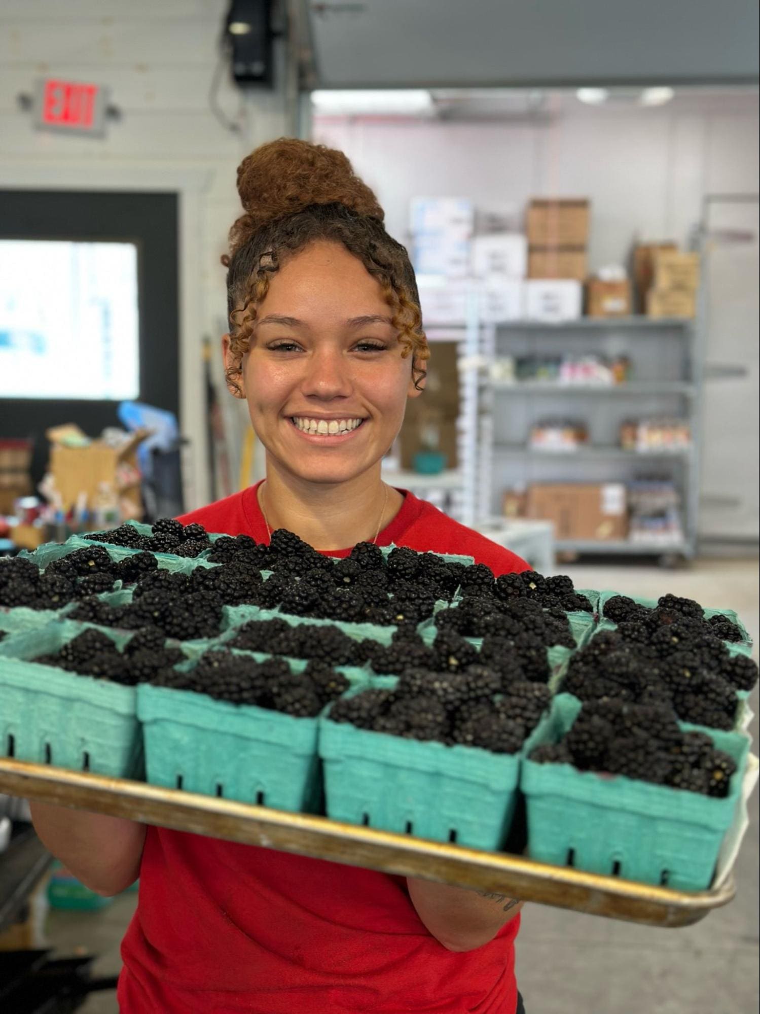 Blackberries held by worker